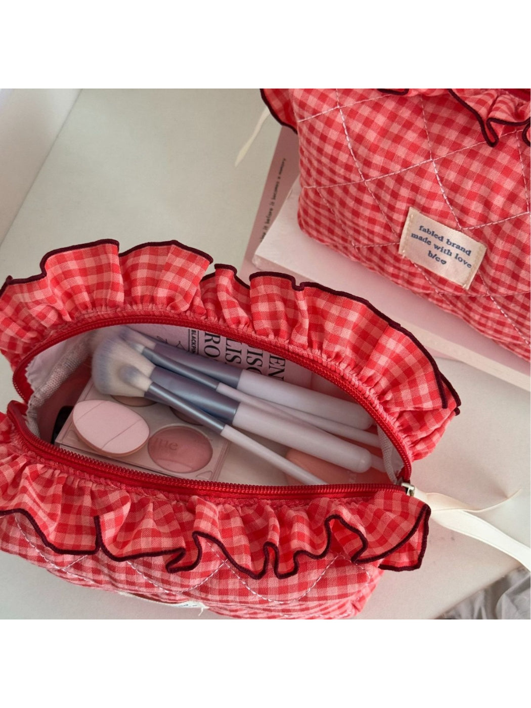 Close-up of ruffle trim detail on Cosbai gingham makeup bag