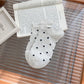 Rufia Everyday Polka Dot Socks worn on feet with black polka dots on white background