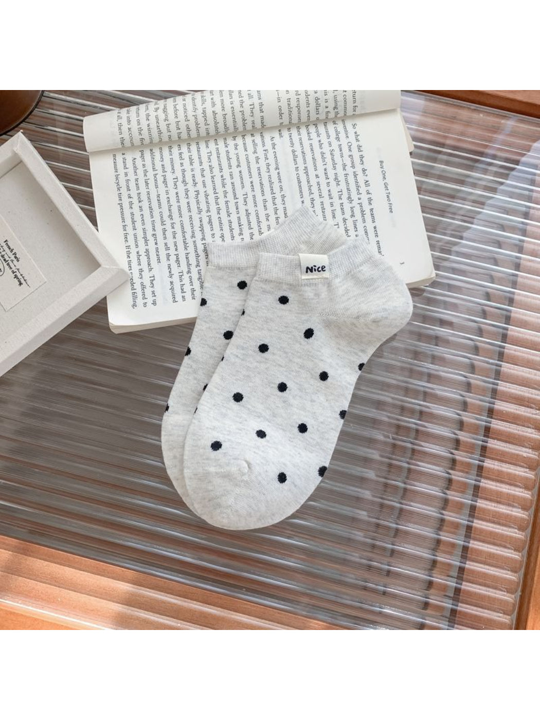 Rufia Everyday Polka Dot Socks worn on feet with black polka dots on white background