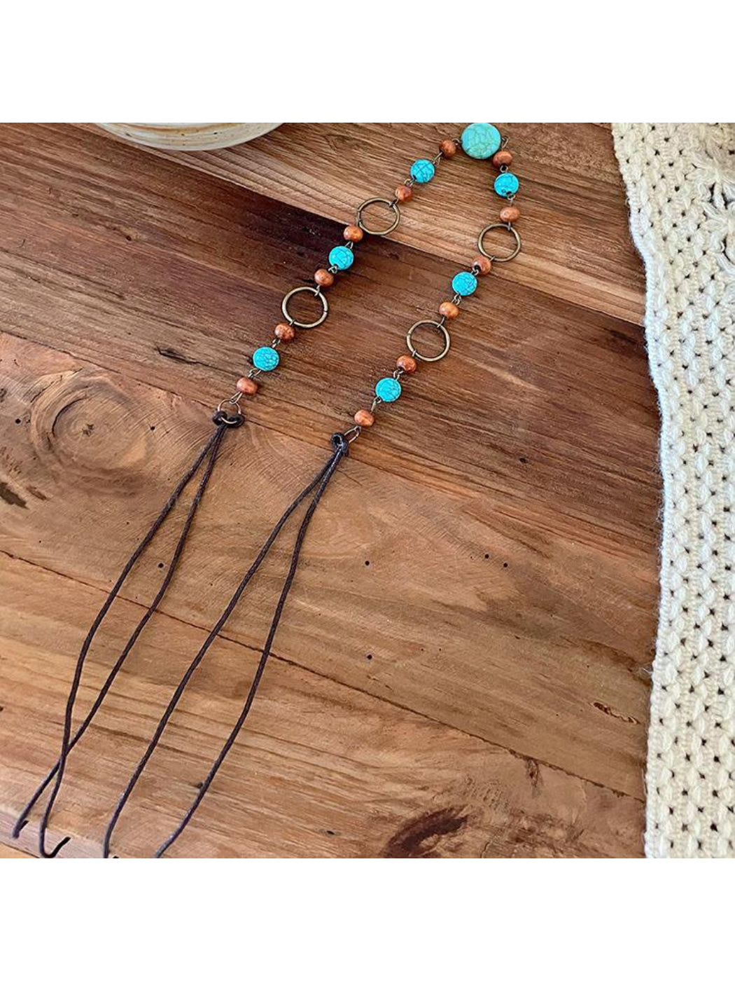 Beco Boho waist belt laid out with ring detail centered and strap ends visible