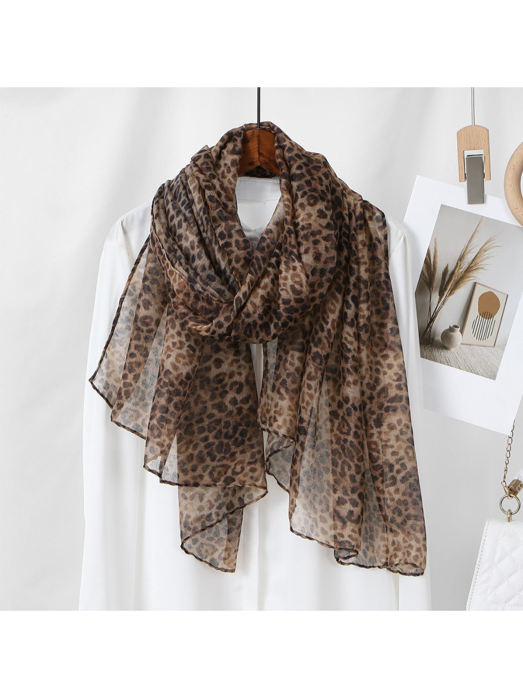 Folded leopard print scarf displaying soft texture and colors