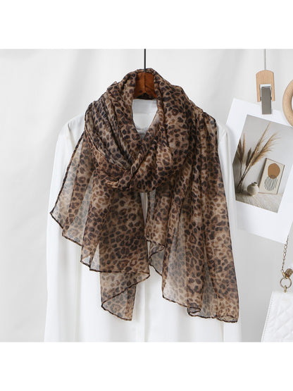 Folded leopard print scarf displaying soft texture and colors