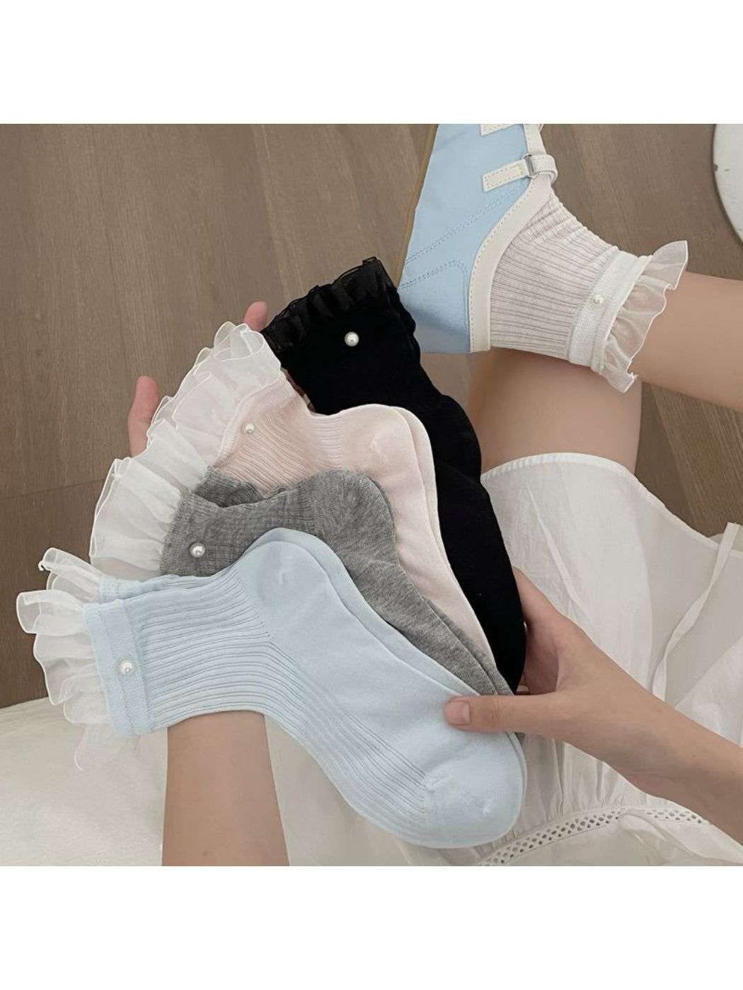 Close-up of Rufia sheer crew sock ruffle trim detail in white
