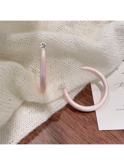 Side view of glossy color hoop earrings highlighting thickness