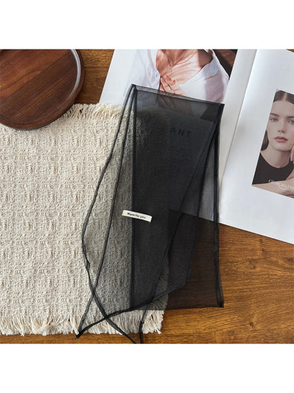 Scarf folded neatly with visible edges and soft, flowing material