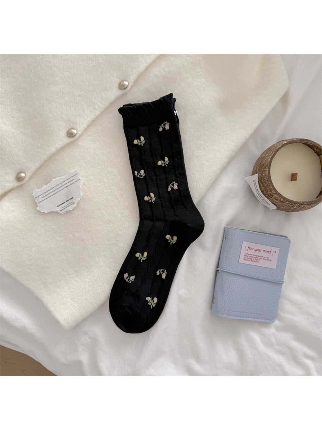 Pair of Rufia floral crew socks laid flat highlighting bead embellishments