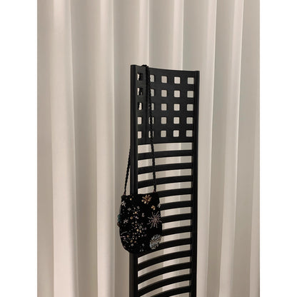 Cosbai beaded floral drawstring crossbody bag displayed hanging by its strap
