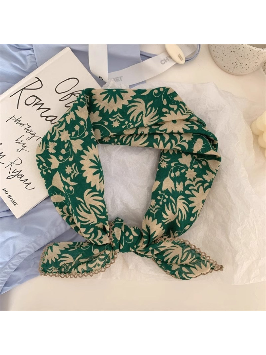Scarvii scarf draped over shoulder showing soft texture and colorful botanical pattern