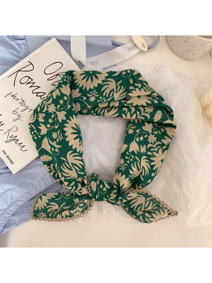 Scarvii scarf draped over shoulder showing soft texture and colorful botanical pattern