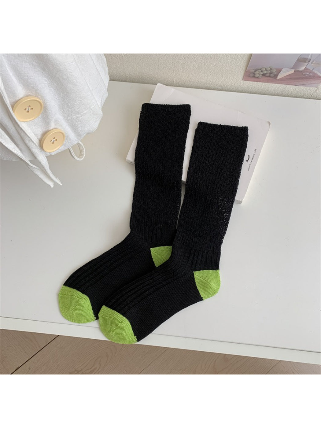 Rufia socks folded to display contrast toe and ribbed cuff design