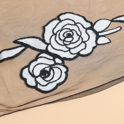 Folded sheer rose mesh scarf showing lightweight and translucent texture