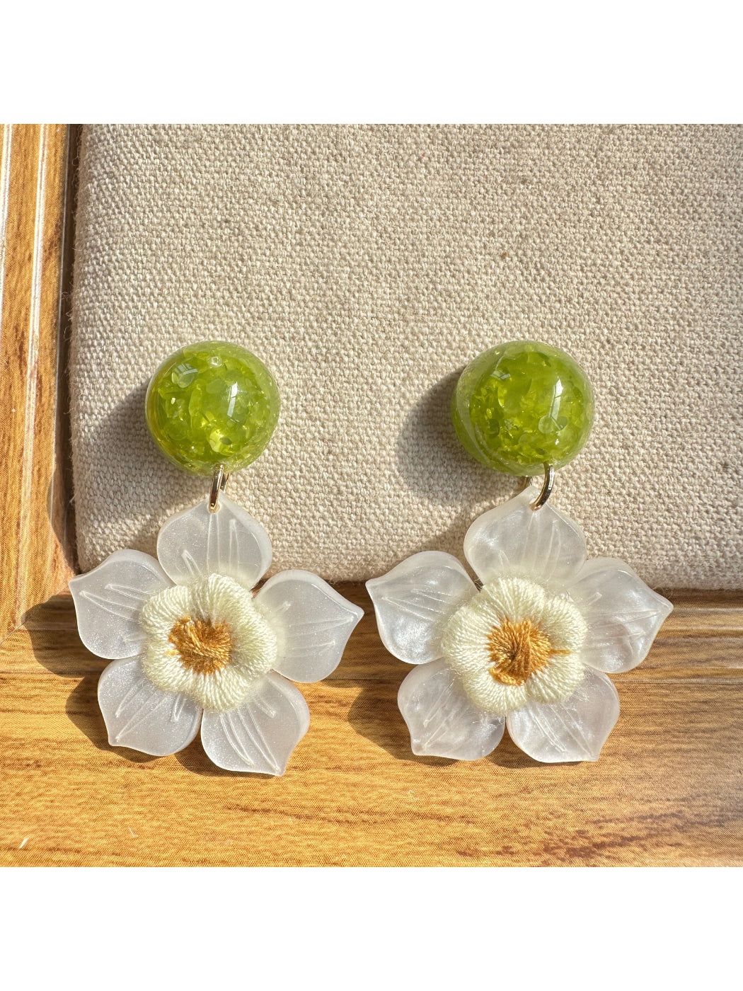 Side view of Earwish white flower drop earrings showing delicate petal details