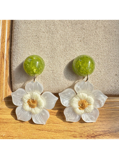 Side view of Earwish white flower drop earrings showing delicate petal details