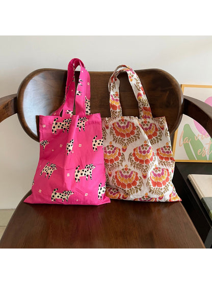 Close-up of Cosbai tote bag showing detailed colorful print and sturdy handles
