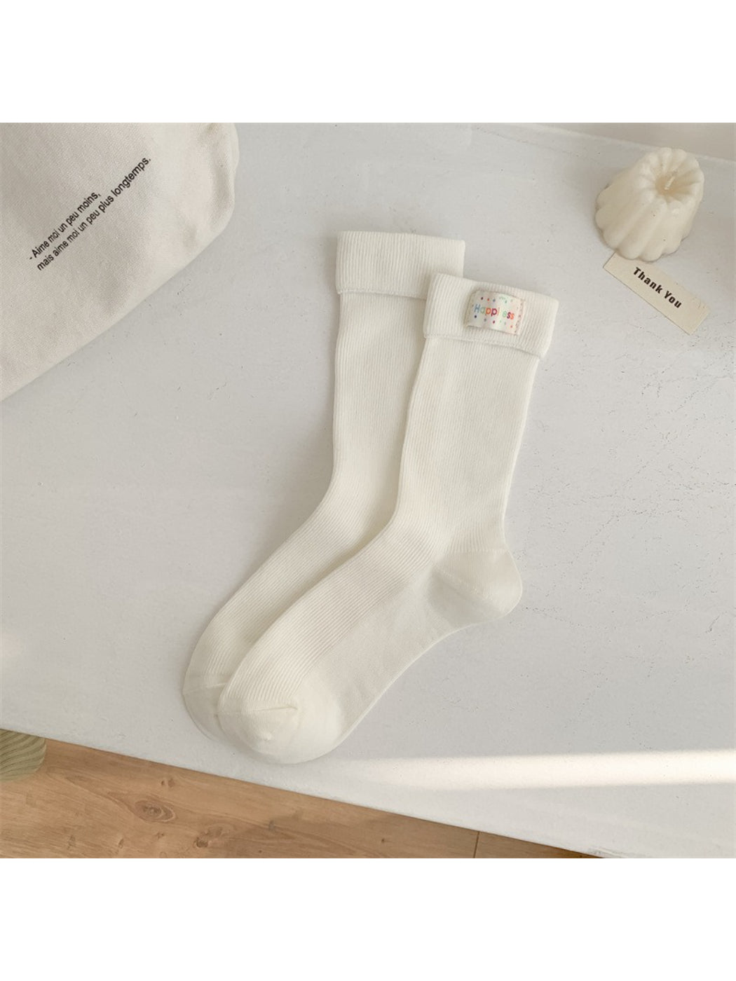 Stacked Rufia crew socks displaying multiple stripe color variations and thickness