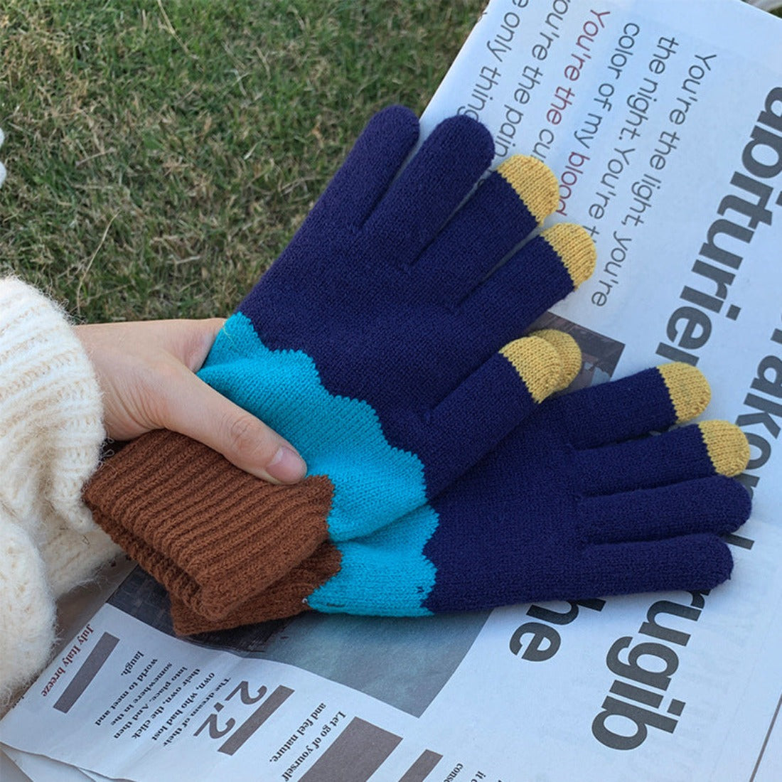 Knitting patchwork touchscreen gloves displayed on white background