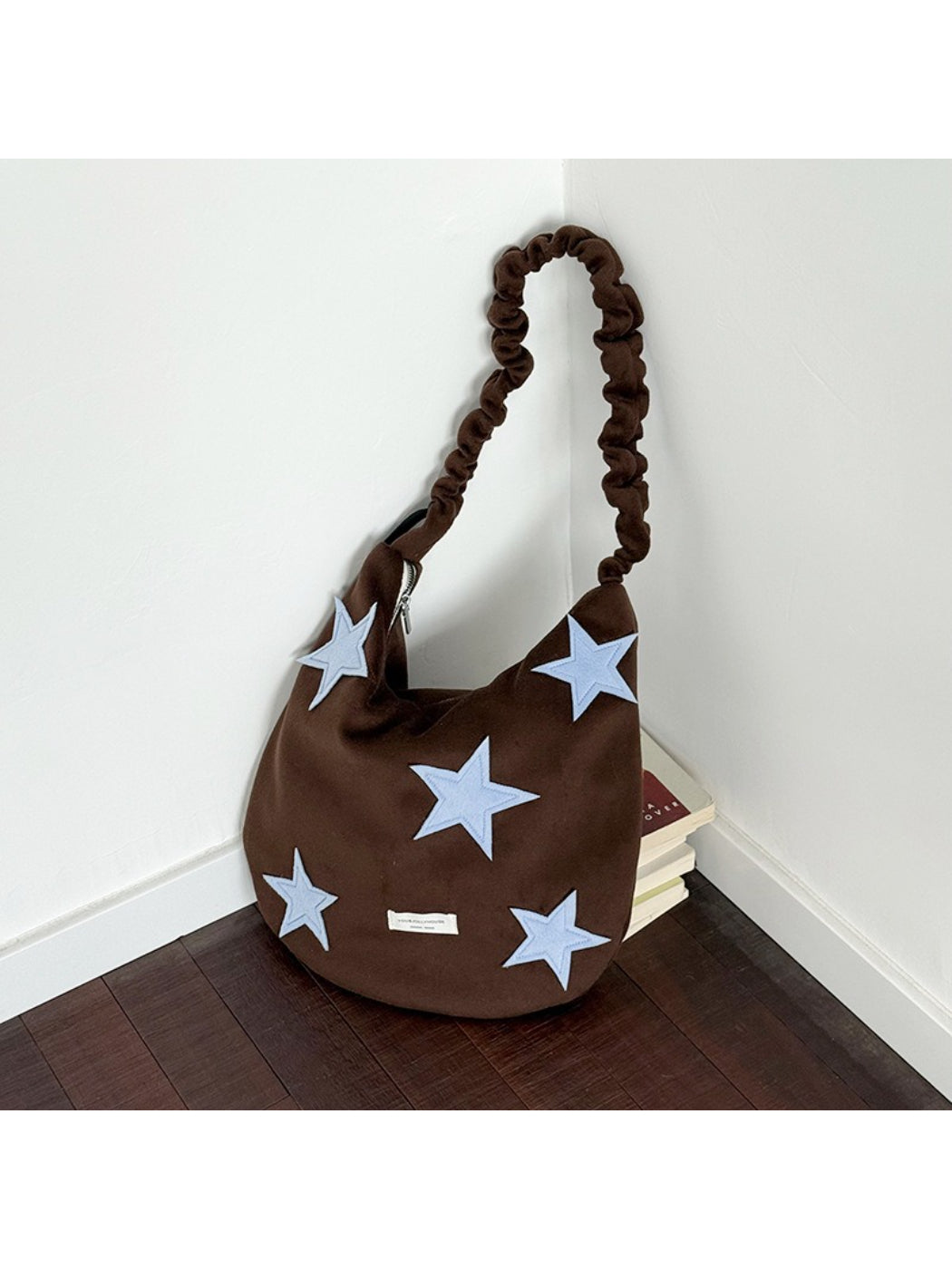 Cosbai slouchy shoulder bag worn on shoulder by model in casual outfit
