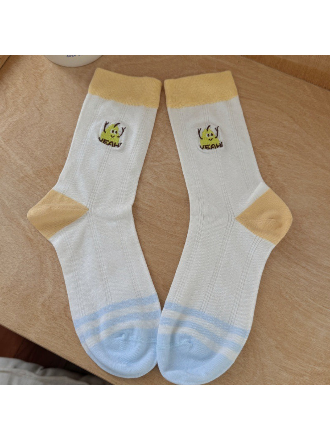 Side view of Rufia playful fruit detail socks on a model's feet