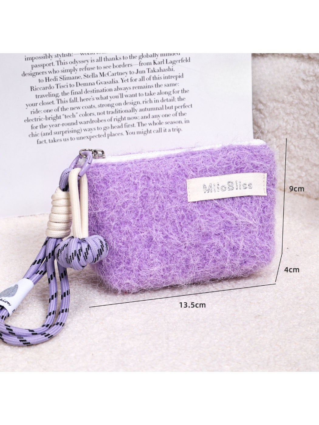 Cosbai fluffy mini pouch with wrist cord shown hanging by the cord