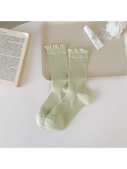 Model wearing Rufia Everyday Ruffle Cuff Crew Socks with a casual outfit outdoors