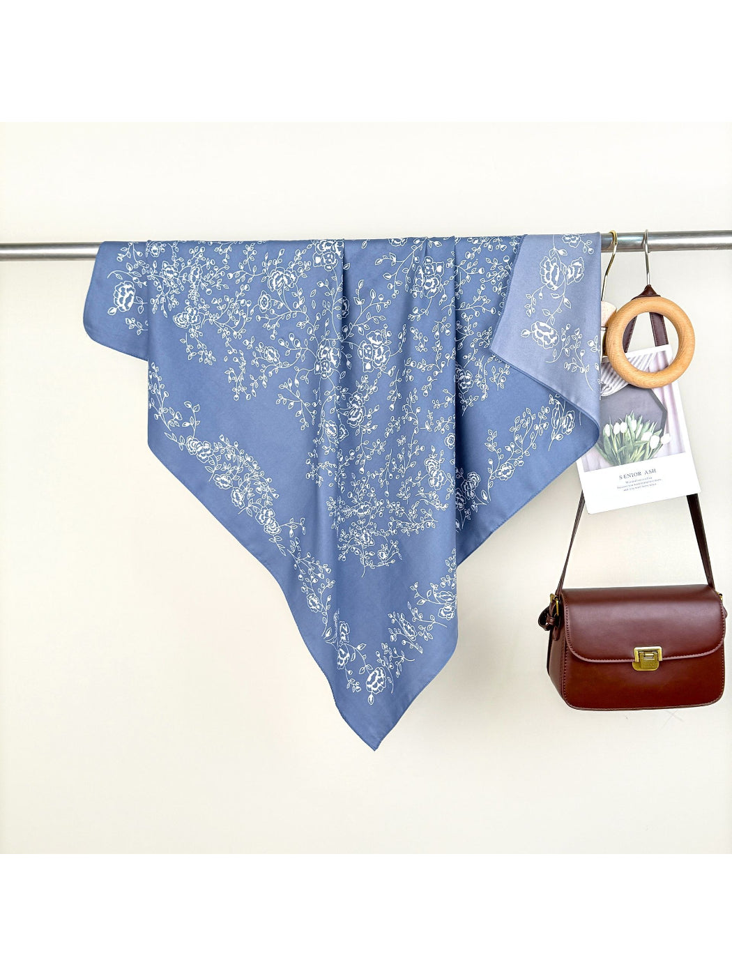 Model wearing Scarvii bandana as a neck scarf with vine and floral pattern