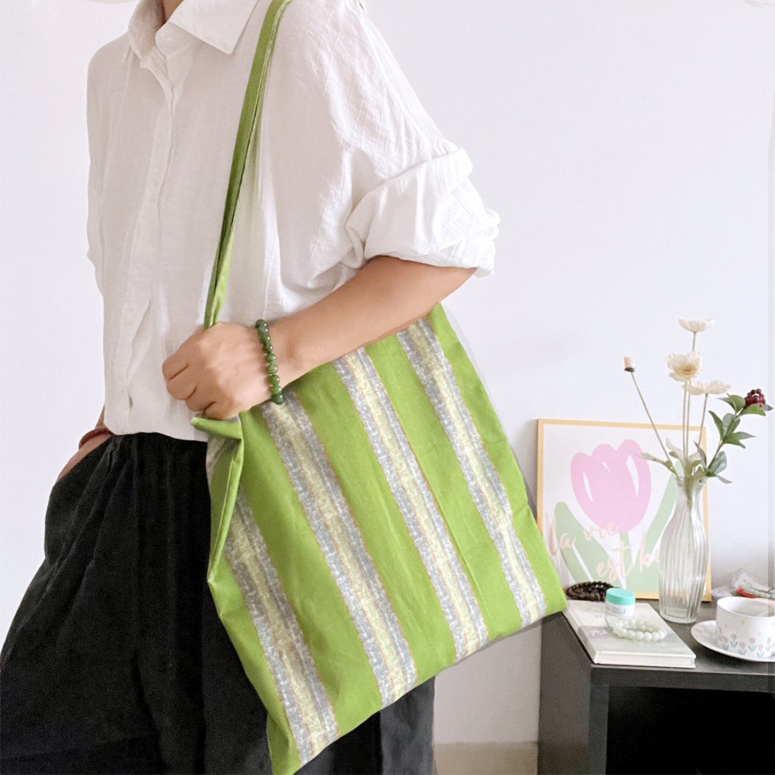 Close-up of Cosbai tote bag showing striped fabric and stitching details