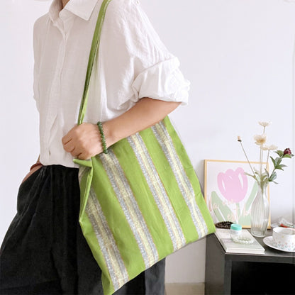 Close-up of Cosbai tote bag showing striped fabric and stitching details