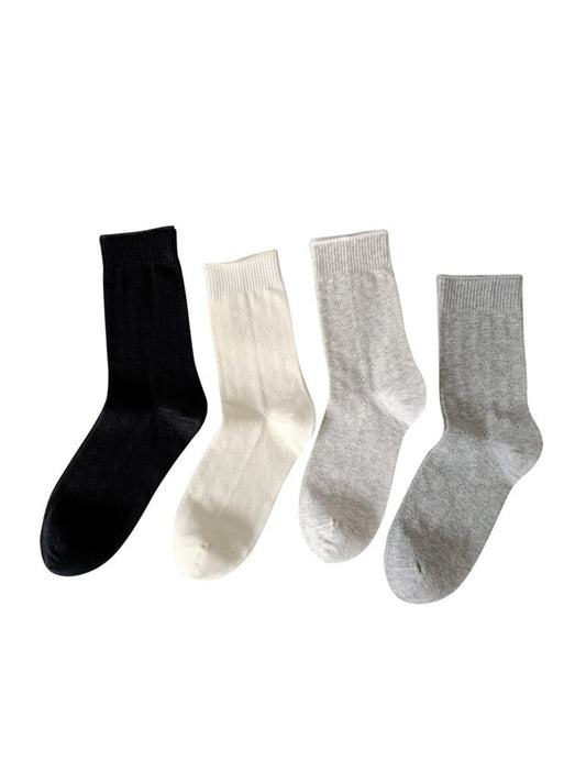 Pair of Rufia knit white crew socks laid flat on a white background
