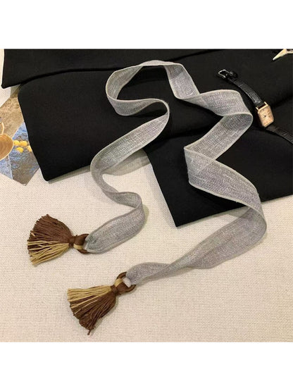 Scarvii boho tassel trim skinny scarf styled with a light jacket outdoors