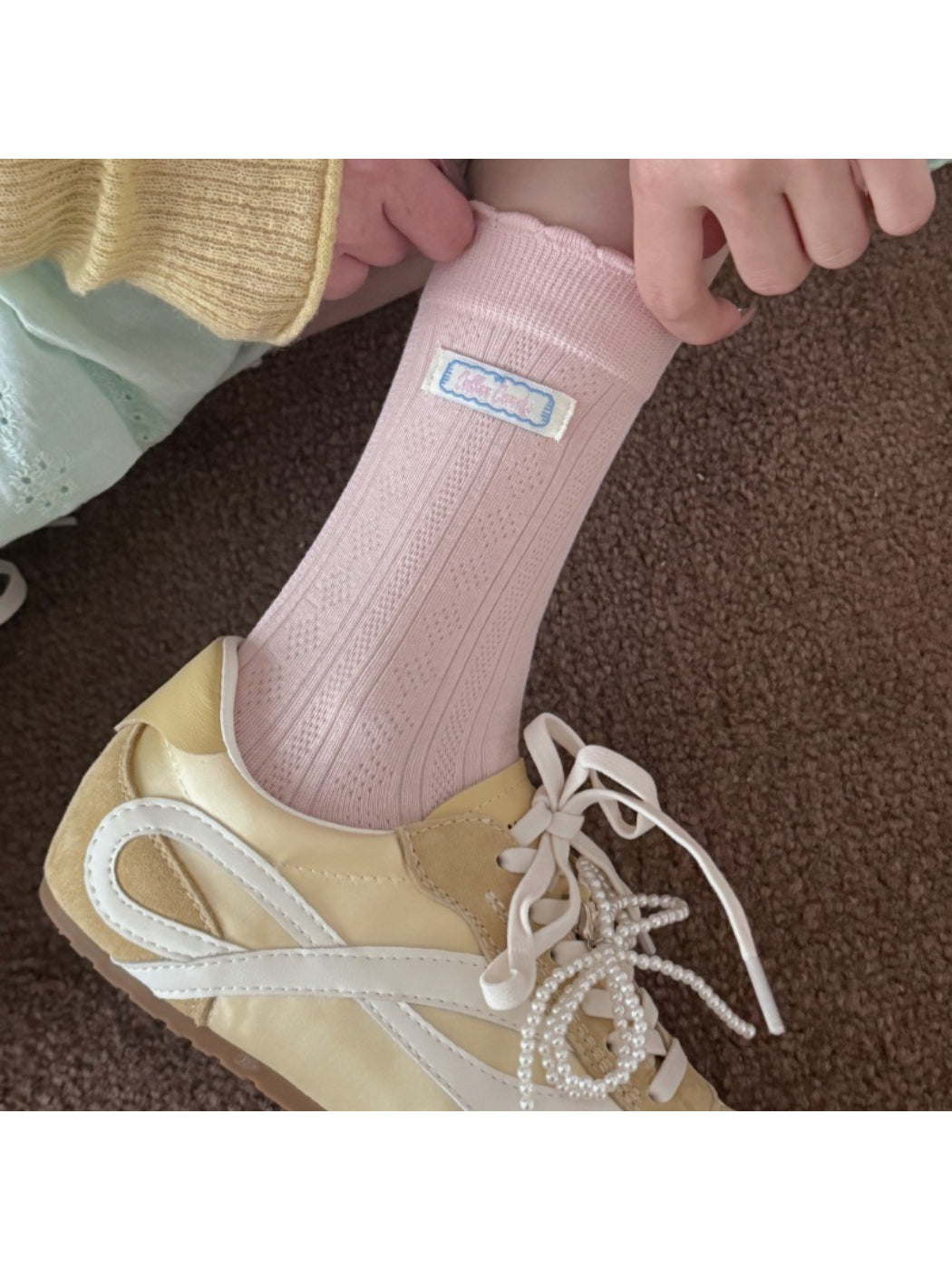 Close-up of scalloped edge detail on Rufia soft trim socks in beige