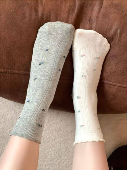 Rufia socks styled with casual shoes, lace trim and motifs visible