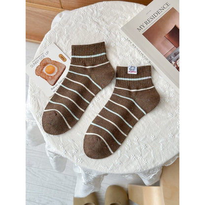 Rufia casual crew socks folded neatly on a wooden surface