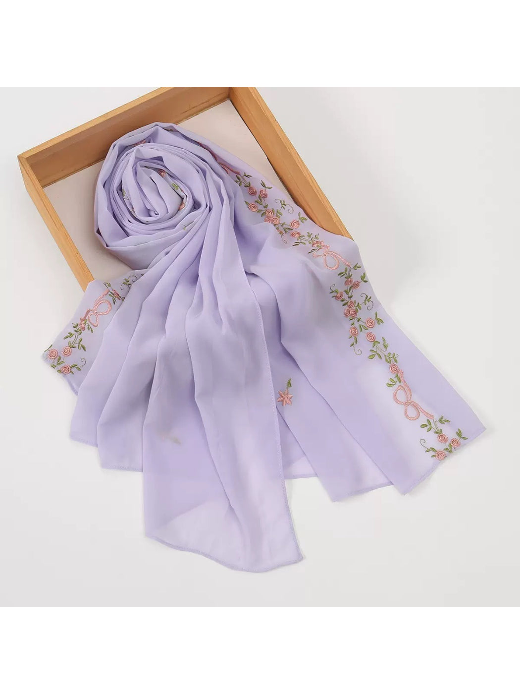 Scarf styled with casual outfit highlighting embroidered details