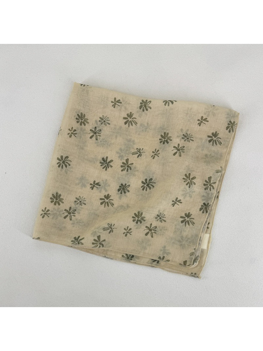 Scarvii scarf draped over shoulder highlighting lightweight fabric and daisy print