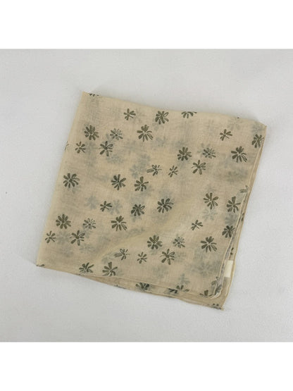Scarvii scarf draped over shoulder highlighting lightweight fabric and daisy print