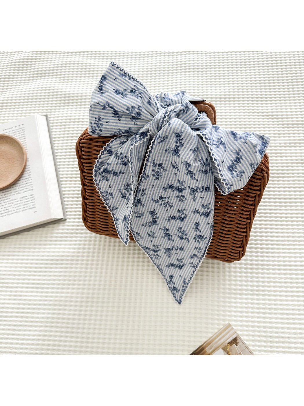 Close-up of floral and stripe design on lace skinny scarf in soft pastel colors