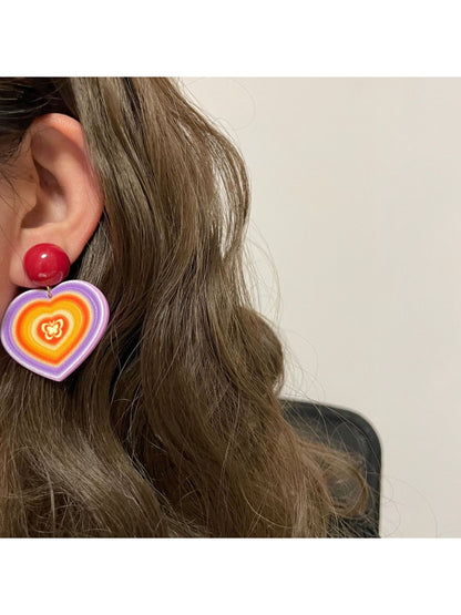 Close-up of Earwish Rainbow Heart Drop Earrings showing vibrant colors and heart shape