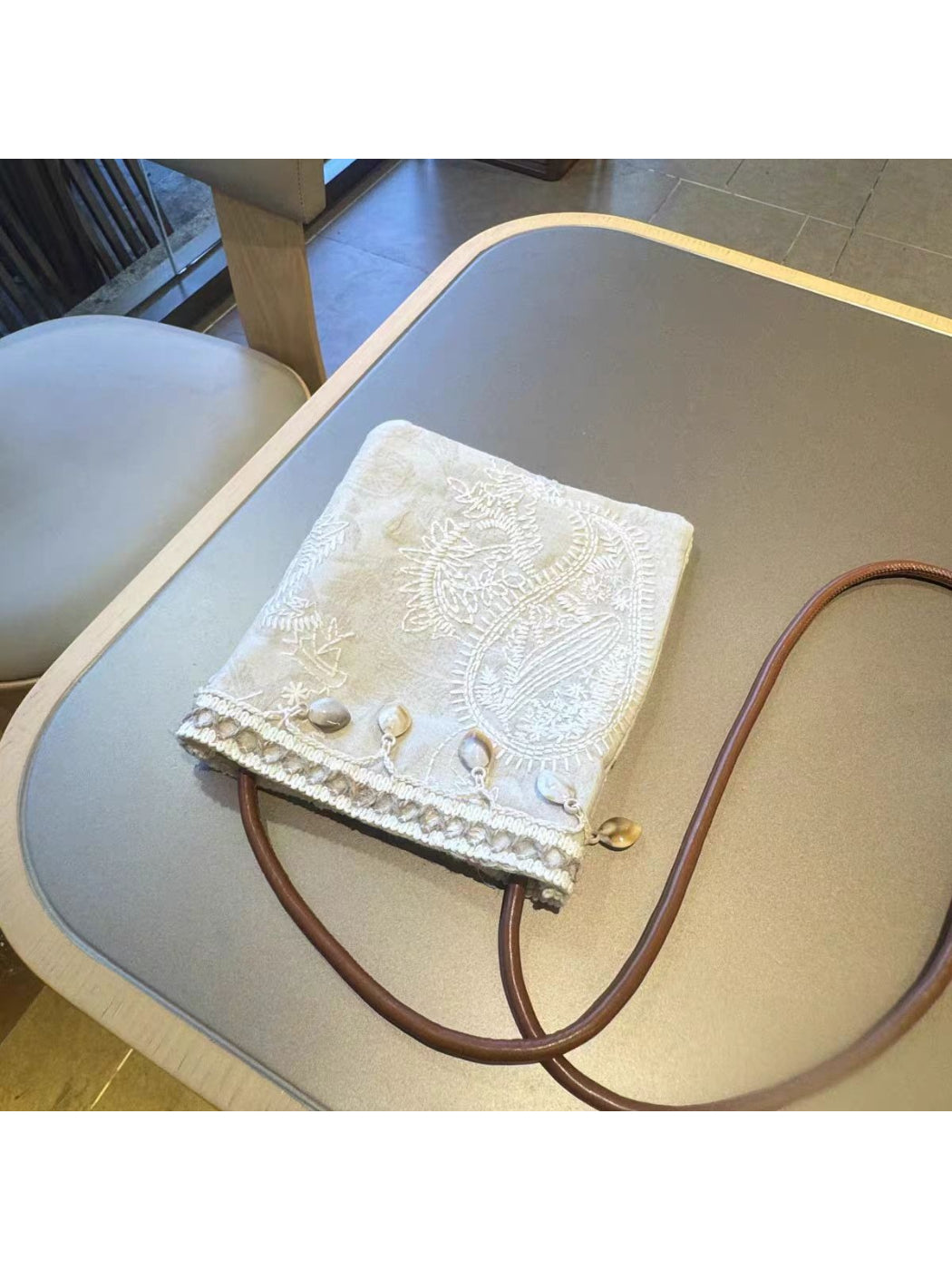 Cosbai textured floral crossbody bag in beige with embossed flower pattern and adjustable strap