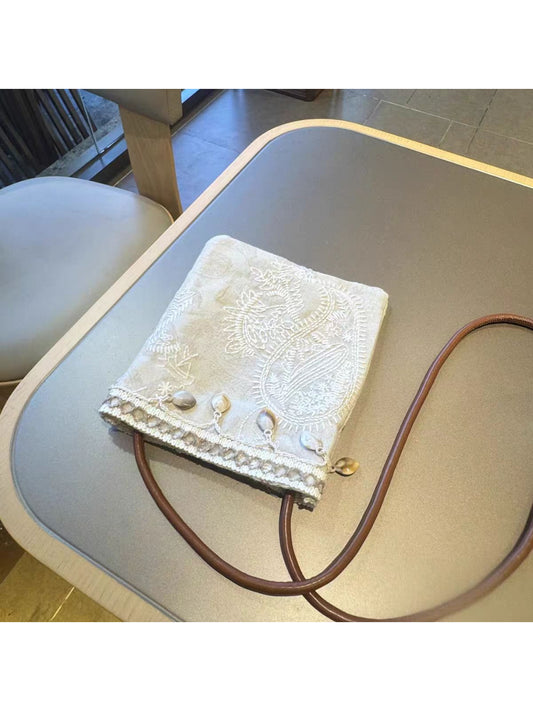 Cosbai textured floral crossbody bag in beige with embossed flower pattern and adjustable strap