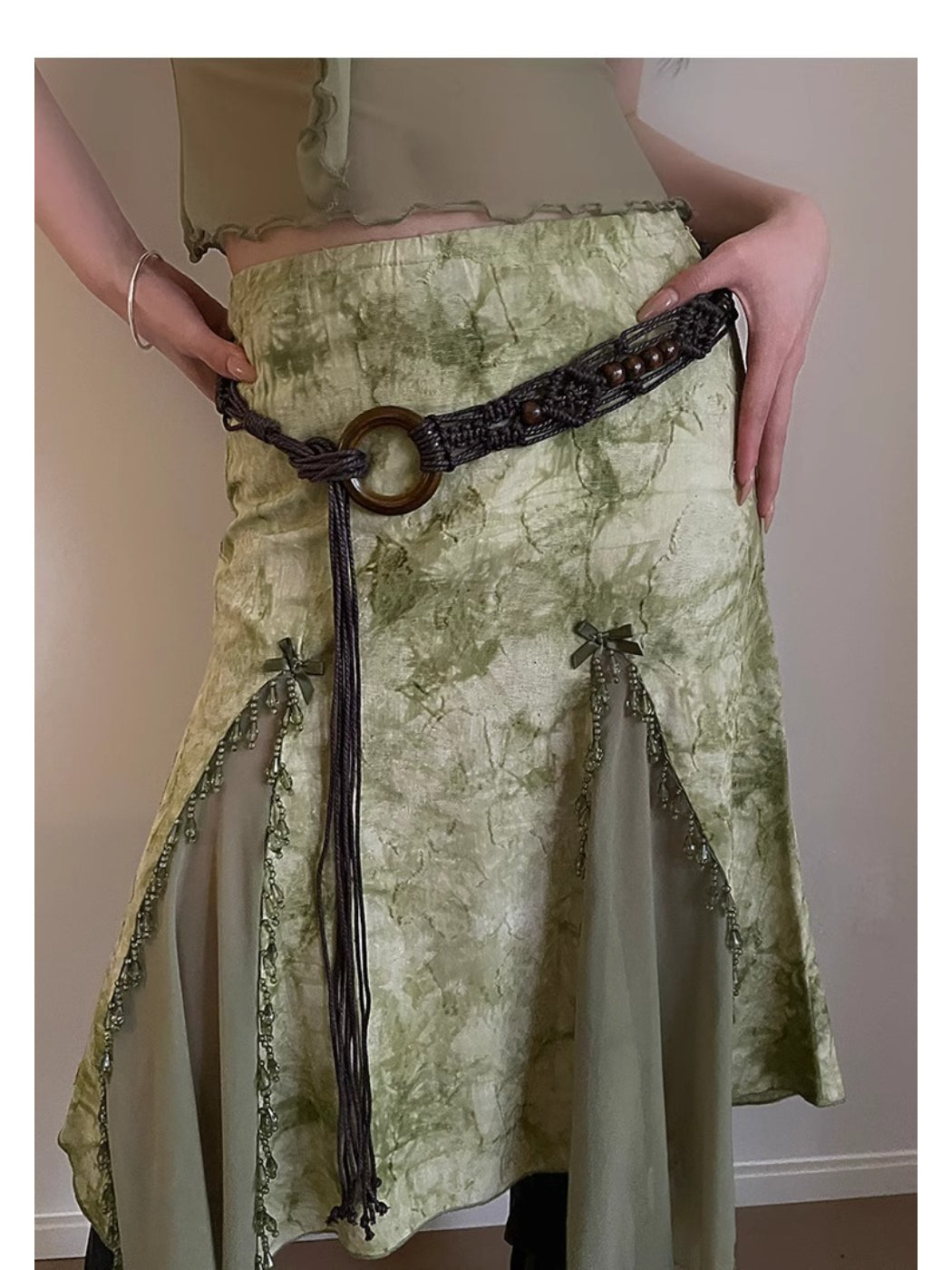 Flat lay of Beco Boho braided rope waist belt coiled with visible texture and natural color