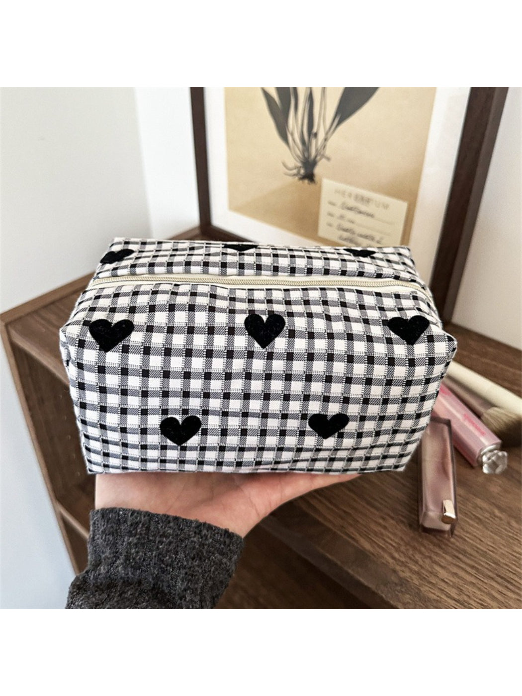 Black and white heart patterned makeup bag on a white background