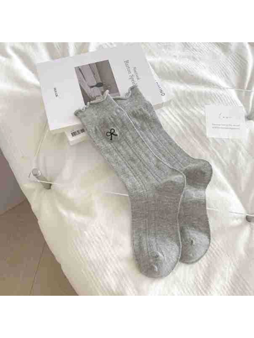 Detail of tiny ribbon bow on Rufia Pointelle Socks in soft pastel color