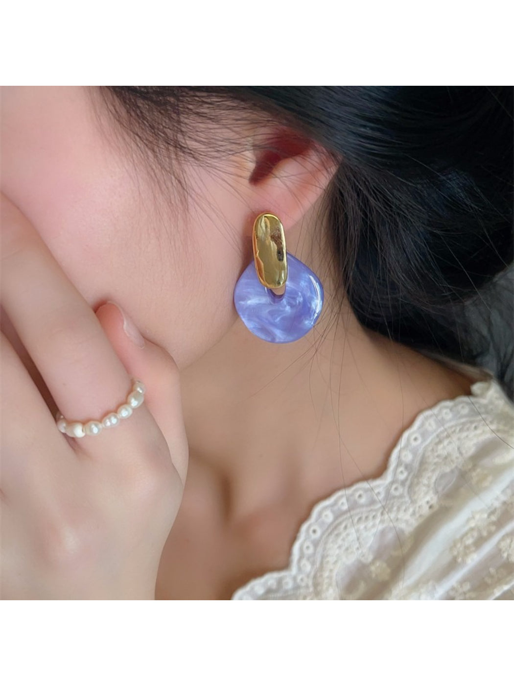Close-up of Earwish pastel green round drop earring showing smooth texture