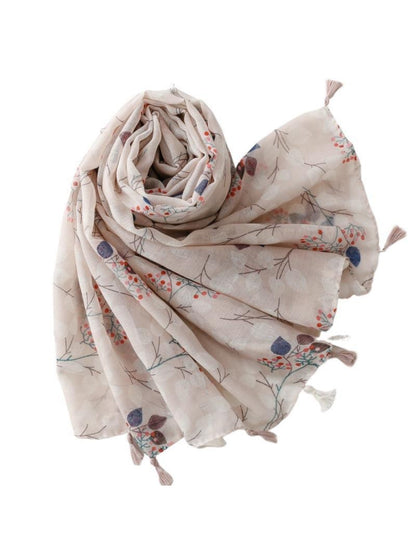 Model wearing the soft botanical print scarf styled around the neck