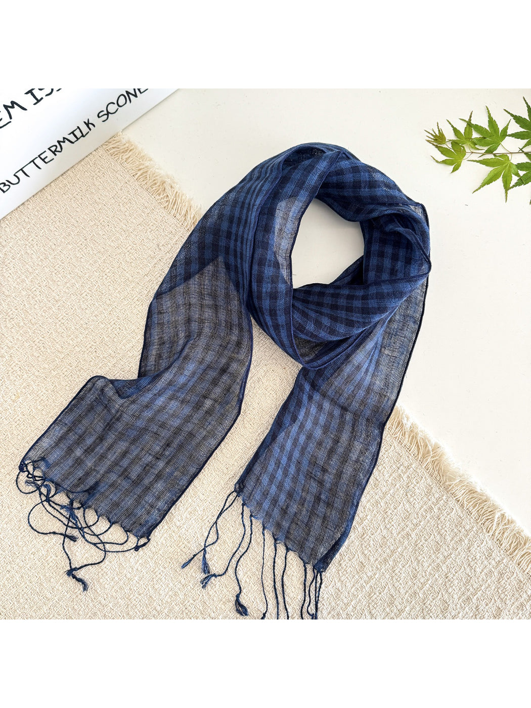 Soft check pattern long skinny scarf displayed with complementary outfit on model