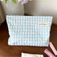 Side view of Cosbai pastel check zip pouch highlighting slim profile