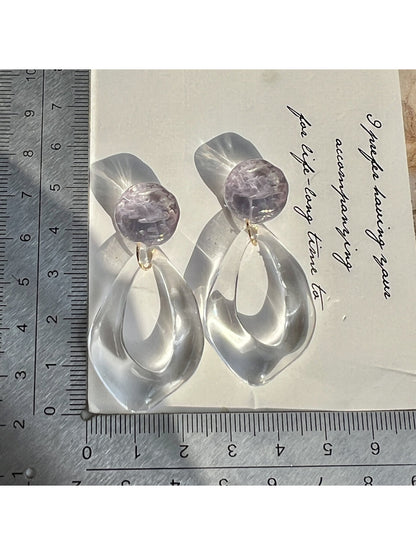 Side view of Earwish clear teardrop hoop earrings showing transparent design