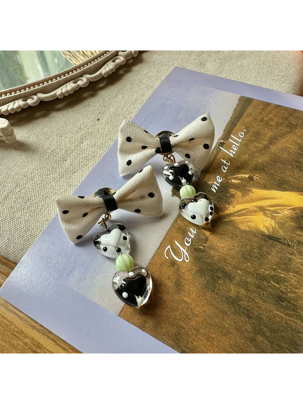 Side view of Earwish Heart Charm Bow Earrings showing bow design and clasp