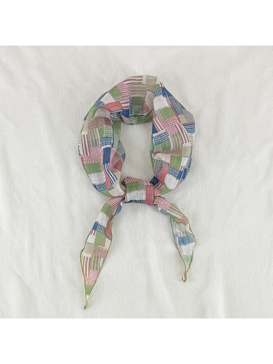 Scarvii vintage patchwork skinny scarf folded neatly on wooden surface