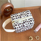 Cosbai soft handle cosmetic bag placed on a flat surface with handle extended